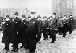 Police wearing masks in response to the Spanish Flu pandemic in 1918 on a street in Seattle, Washington